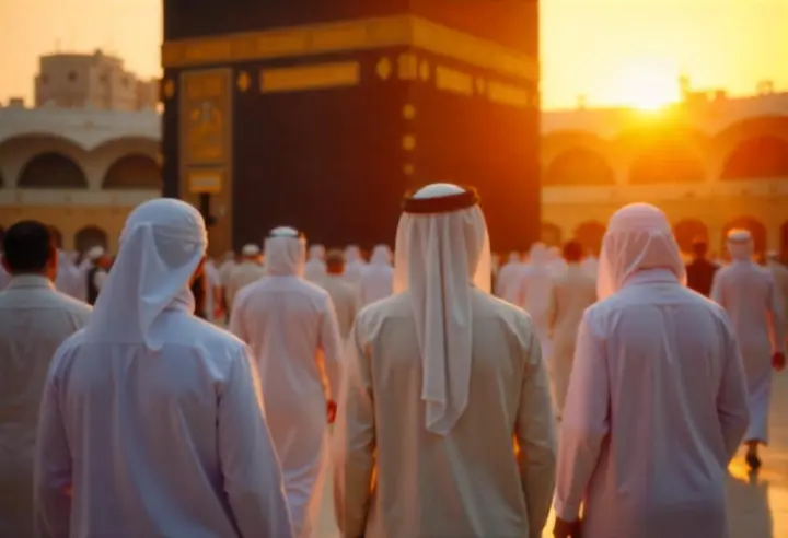 Pilgrims reflecting near Kaaba at sunset, representing lasting memories from Umrah